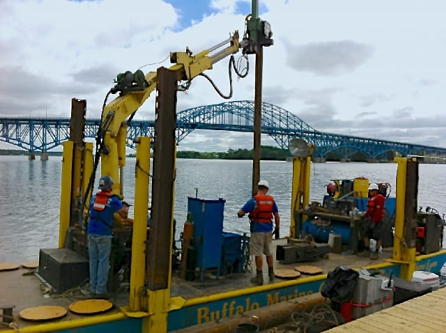Image of workers on barge setting a piling